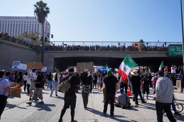 Protesters block the 101 Freeway near the metropolitan detention center...