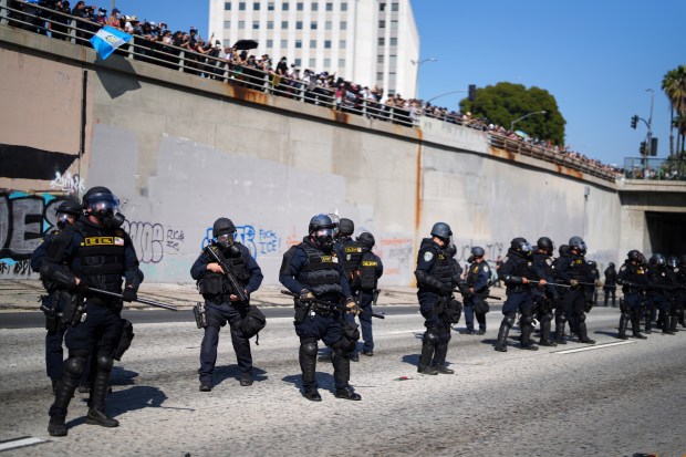 Police line up on the 101 Freeway near the metropolitan...