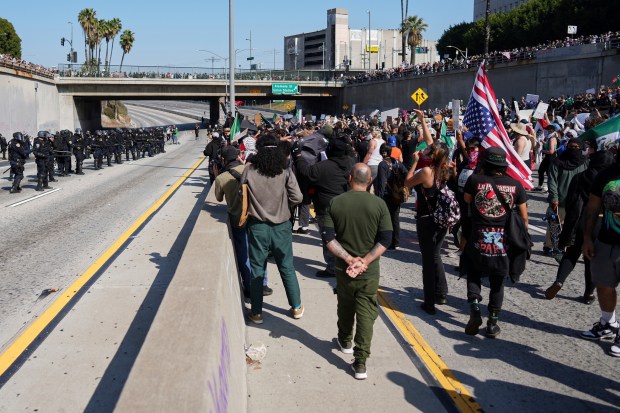 Police are seen on one side of the 101 Freeway...