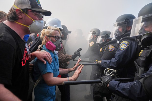 Protesters confront police on the 101 Freeway near the Metropolitan...