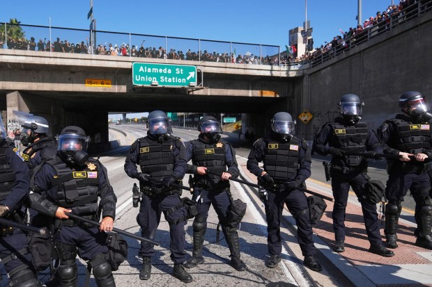 Police are lined up on the 101 freeway near the...