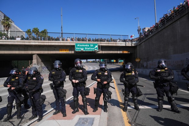 Police are lined up on the 101 freeway near the...
