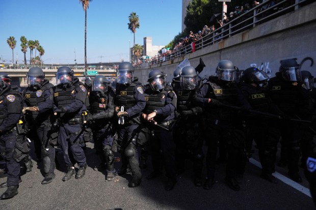 Police are lined up on the 101 freeway near the...