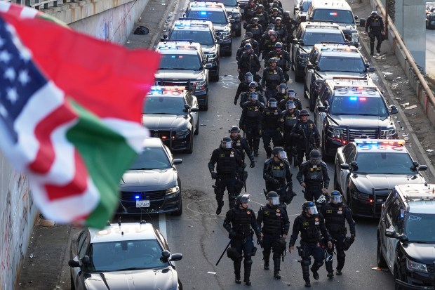 Officers make their way down a ramp to the 101...