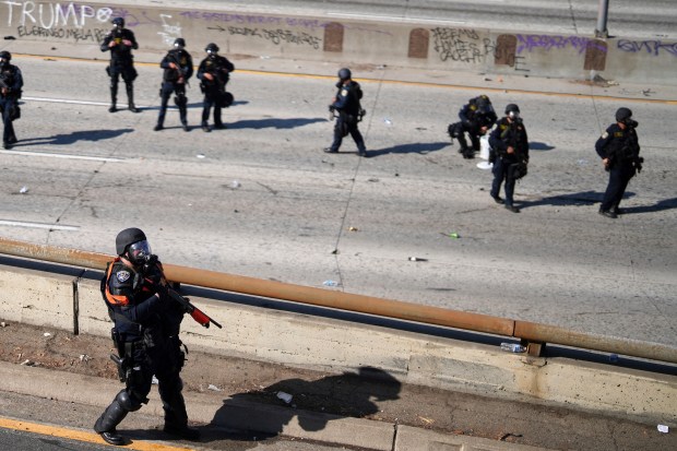 Police officers are seen on the 101 Freeway near the...