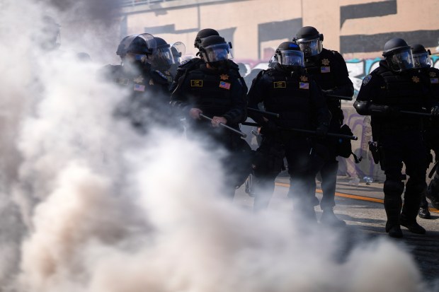 Police officers are seen on the 101 Freeway near the...