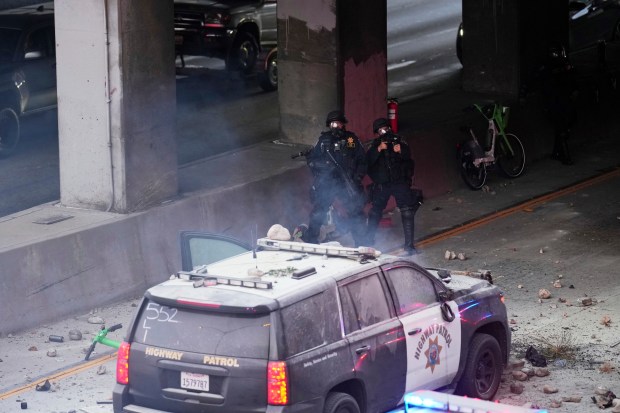 Protesters throw objects at California Highway Patrol vehicles on the...