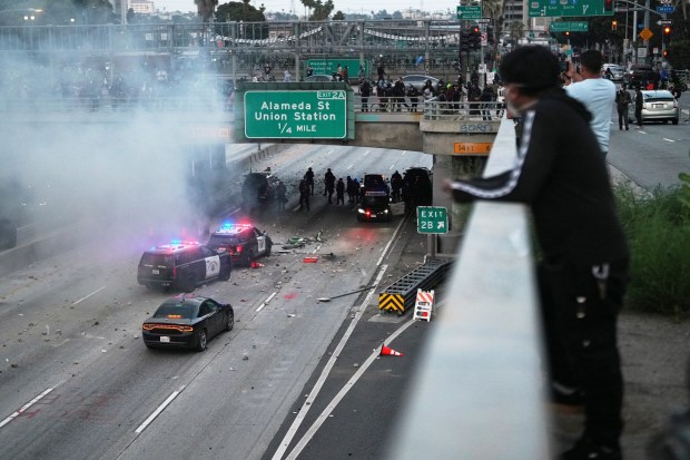 Protesters throw objects at California Highway Patrol vehicles on the...