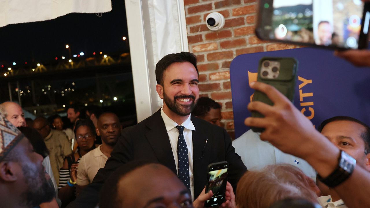 Zohran Mamdani takes selfies with supporters after speaking at his primary election party in New York. (AP Photo/Heather Khalifa)