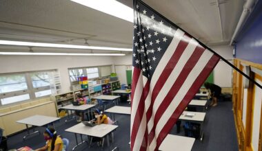 An American flag hangs in a classroom. (AP Photo/David Zalubowski)