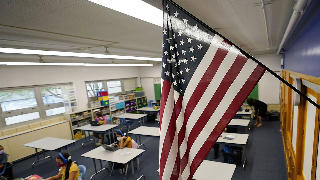 An American flag hangs in a classroom. (AP Photo/David Zalubowski)