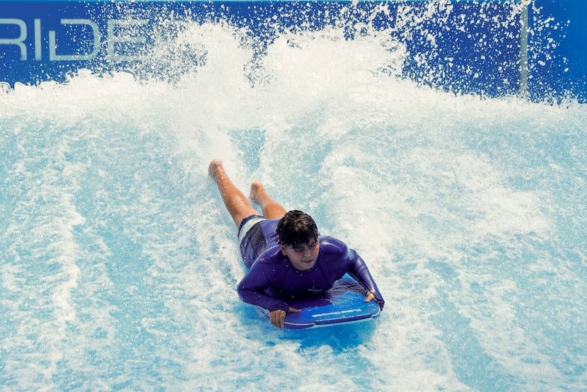 Christopher Garcia, 10, boogie boards on the FlowRider at Epic Waters in Grand Prairie,...
