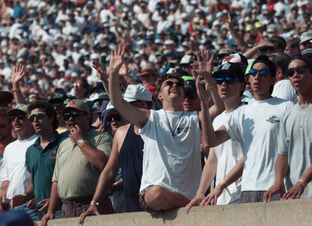 A participant in the Promise Keepers, a non-denominational Christian movement, raises his hands to the sky during a hymn on June 29, 1996, at Soldier Field in Chicago. The two-day, male-only event was expected to draw over 77,000. (Beth A. Keiser/AP)