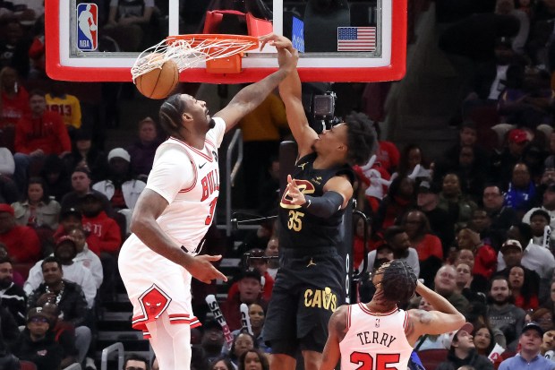 Cavaliers forward Isaac Okoro dunks on Bulls center Andre Drummond on Feb. 28, 2024, at the United Center. (Terrence Antonio James/Chicago Tribune)
