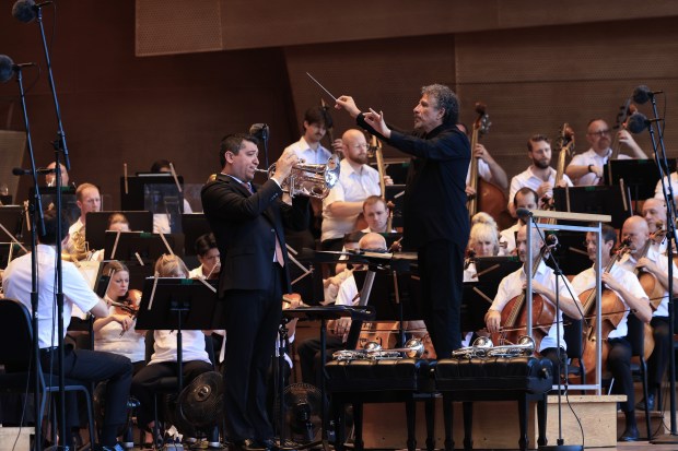 Trumpeter Pacho Flores performs as Giancarlo Guerrero conducts the Grant...