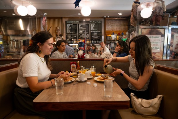 Chiara Voceri, left, and Eleonora Tomassetti, both originally from Rome, start their Route 66 journey with a pancake breakfast at Chicago's Lou Mitchell's on June 22, 2025. (E. Jason Wambsgans/Chicago Tribune)