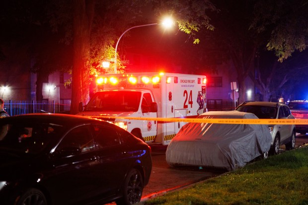 An ambulance is parked at the scene where Chicago police...