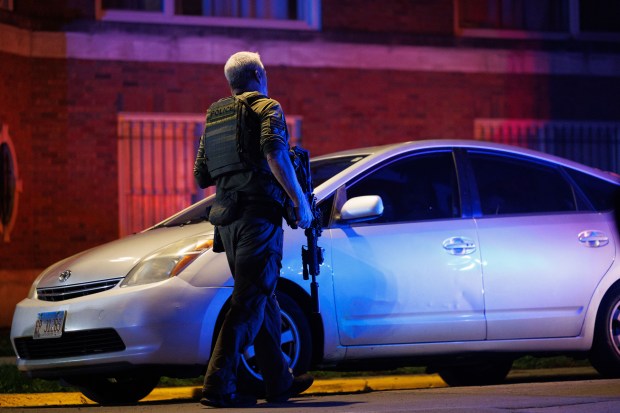 A member of the Chicago police SWAT team walks near...