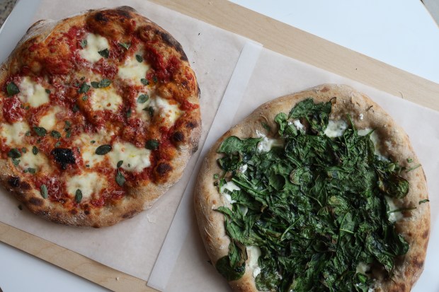 Two whole pizzas seen on a shelf at Great Lake business on June 24, 2025. (Antonio Perez/Chicago Tribune)