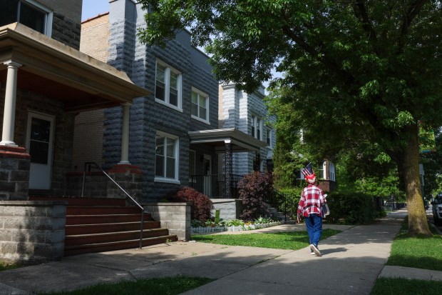 A person walks near the home of Krystal Rivera, the...