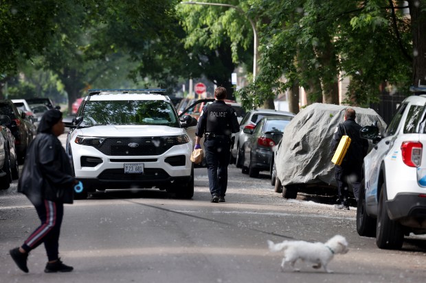 Chicago police carry out evidence bags as they finish up...