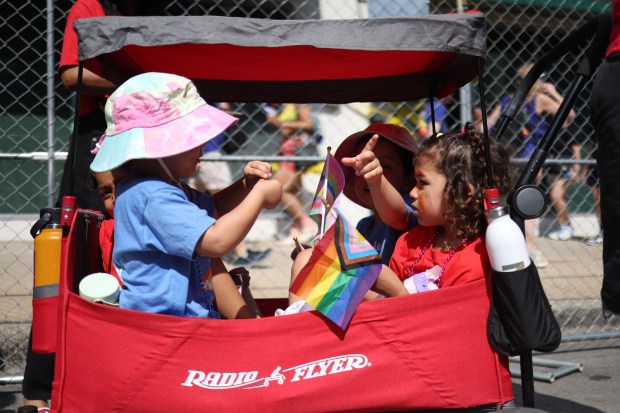 Sonny Meyer-Bellomo, 4, right, with Near North Montessori rides along Broadway Street with her friends before the 54th annual Chicago Pride Parade on June 29, 2025. (Audrey Richardson/Chicago Tribune)