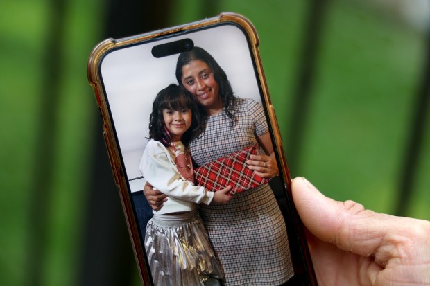 Camerino Gomez shares an image of his partner, Wendy, and her daughter, Gabriela, while outside his home in Chicago on June 11, 2025. (Antonio Perez/Chicago Tribune)