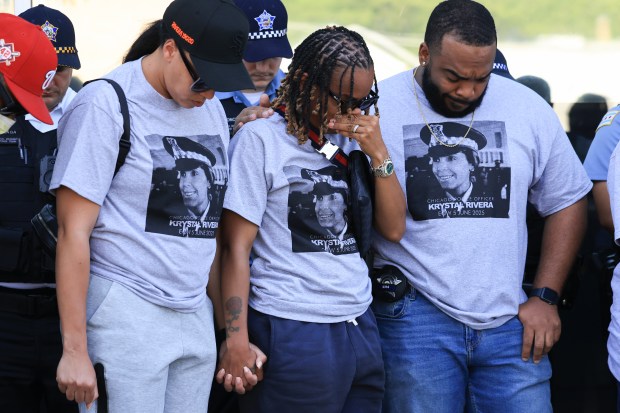 Police officers wear T-shirts with a picture of Officer Krystal...