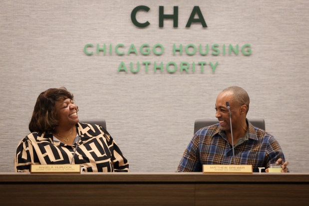 Interim Chicago Housing Authority CEO Angela Hurlock, left, and interim CHA Board Chairman Matthew Brewer talk before a special board meeting on Feb. 20, 2025. (Audrey Richardson/Chicago Tribune)