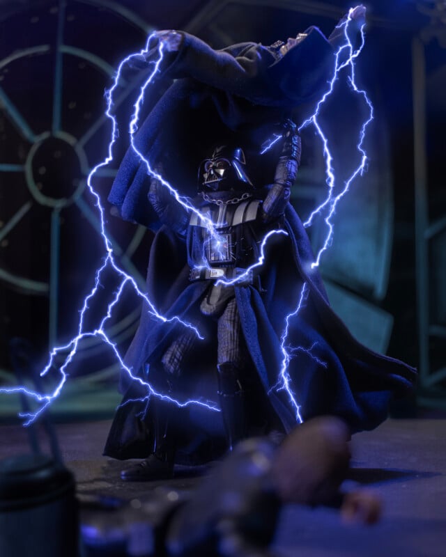 Darth Vader lifts Emperor Palpatine above his head amid crackling blue lightning inside the Death Star, with another figure lying on the floor in the foreground.