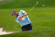 FILE - Padraig Harrington, of Ireland, hits from the bunker on the 18th hole during the...