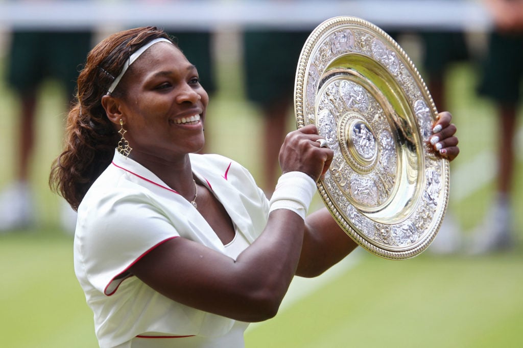 Serena Williams lifting the 2010 Wimbledon title.