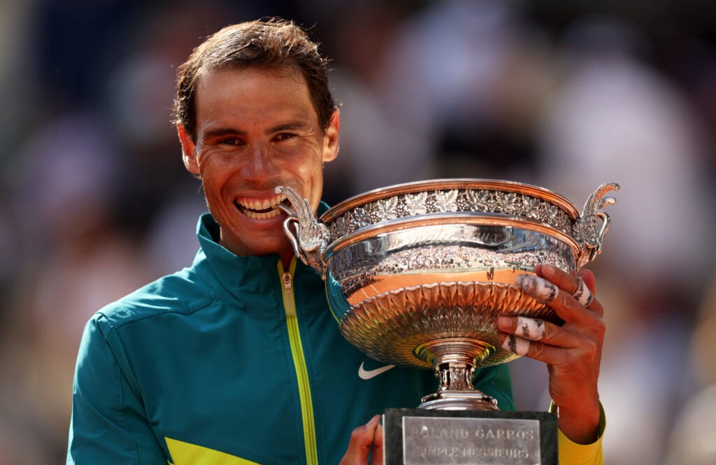 Rafael Nadal of Spain bites the trophy after winning against Casper Ruud of Norway during the Men's Singles Final match on Day 15 of The 2022 French Open at Roland Garros.