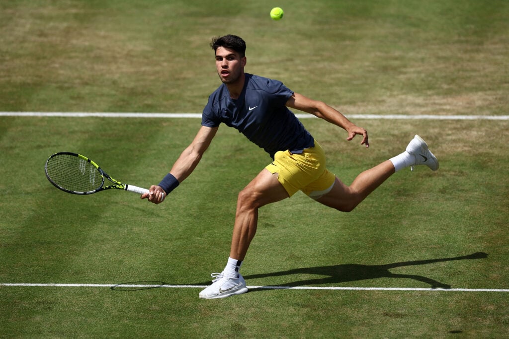Carlos Alcaraz in action at Queen's in 2024