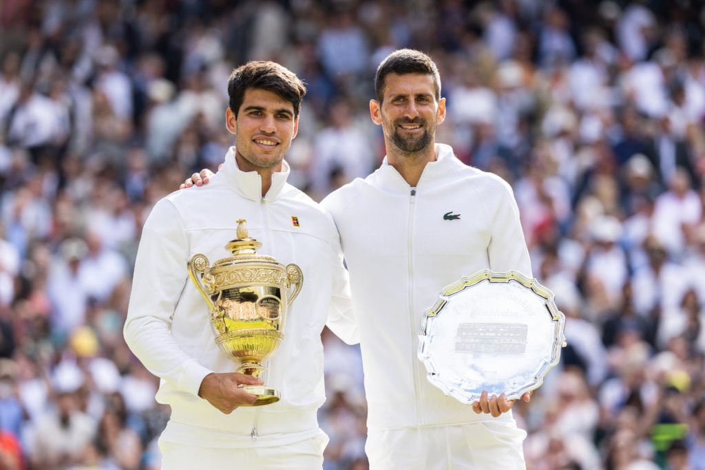 Carlos Alcaraz and Novak Djokovic holding their trophies after the 2024 Wimbledon final.