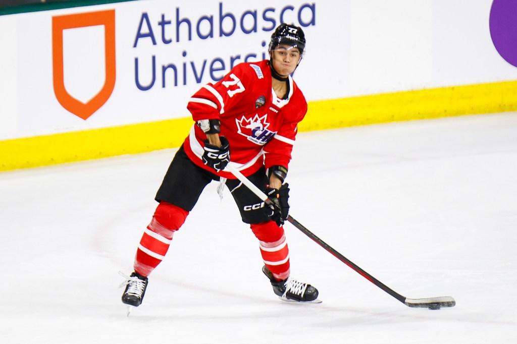 Kashawn Aitcheson #77 of Team CHL gets ready to pass the puck during CHL USA Prospects game between USA and CHL at Canada Life Place on November 26, 2024 in London, Ontario, Canada. 