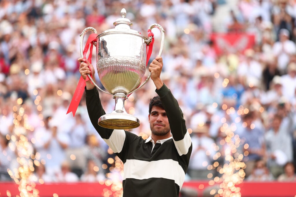 Carlos Alcaraz poses with the trophy after winning the 2025 Queen's Club Championships