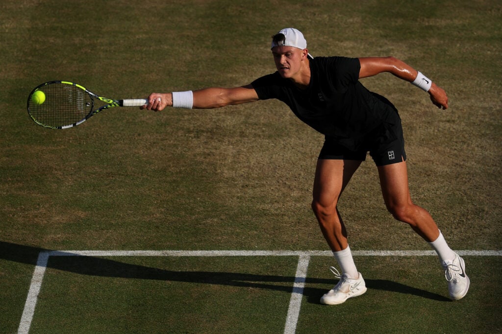 Holger Rune reaching for a forehand at Queen's.