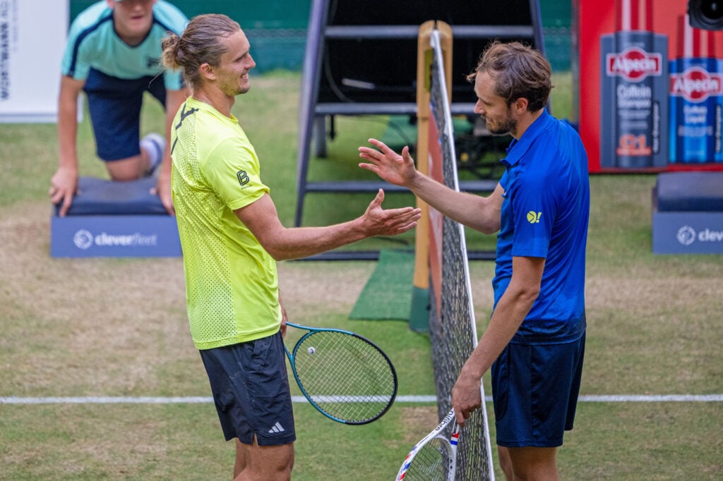 Daniil Medvedev and Alexander Zverev embrace at the net after their match at the 2025 Halle Open