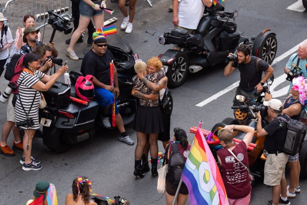 NEW YORK, NEW YORK - JUNE 29: A couple embrace after getting engaged during the 2025 NYC Pride March on June 29, 2025 in New York City. The annual Pride parade is expected to draw more than a million people for the largest Pride event in North America. It will feature 60 floats and over 75,000 marchers. (Photo by Adam Gray/Getty Images)