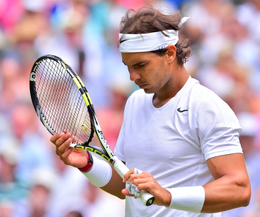 Rafael Nadal looks on during his defeat to Lukas Rosol at Wimbledon in 2014