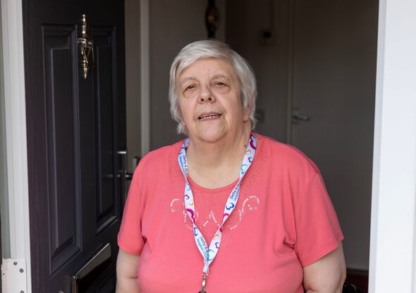 Hefina Williams stands in her doorway