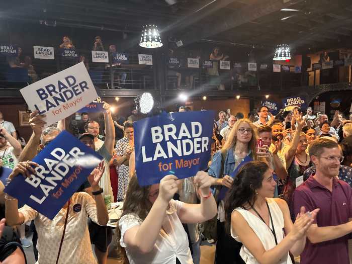crowd of people holding signs at Lander headquarters