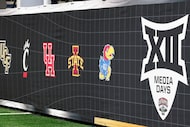Logos for several Big 12 schools are seen during the Big 12 Media Days at AT&T Stadium,...
