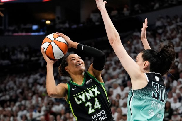 Minnesota Lynx forward Napheesa Collier (24) shoots against New York Liberty forward Breanna Stewart (30) during the second half of Game 4 of a WNBA basketball final playoff series, Friday, Oct. 18, 2024, in Minneapolis. (AP Photo/Abbie Parr)