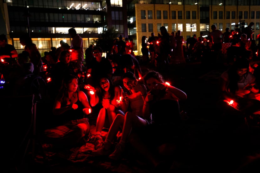 People wear LED bracelets during an LED bracelet experience at the third annual Sensory...