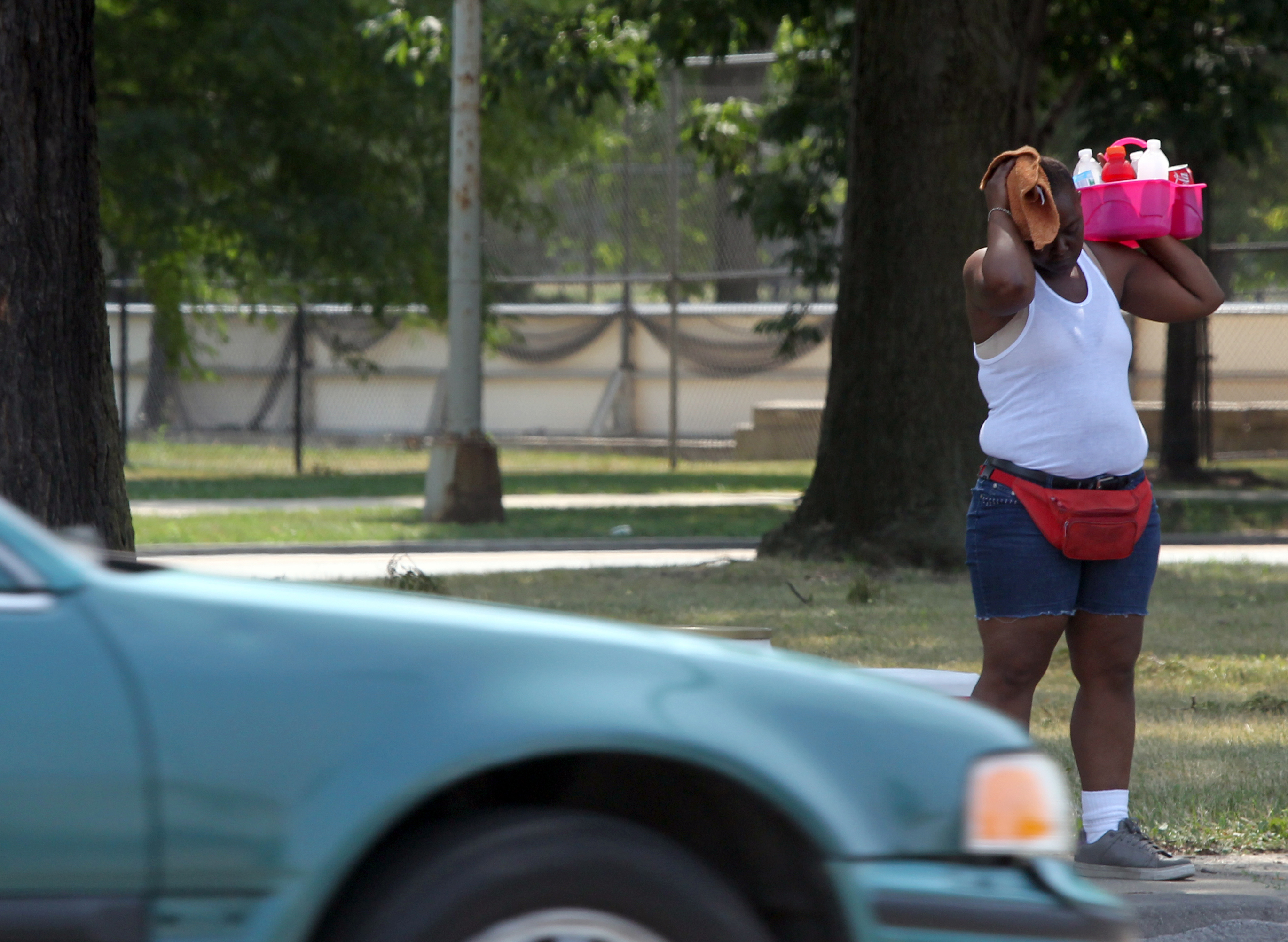 A refreshment street vendor can hardly take the heat herself as she sells her wares at Western Avenue in Chicago during yet another 90-plus degree day on July 5, 2012.