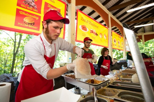 Volunteer Shua Rapoport of Waverly Twp. prepares a shwarma pita...