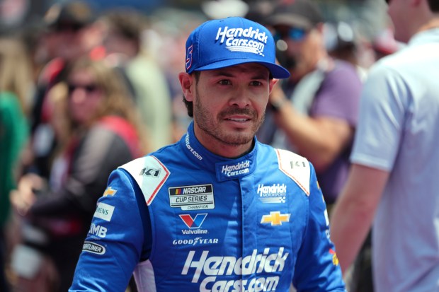 Kyle Larson walks to his car before a NASCAR Cup...
