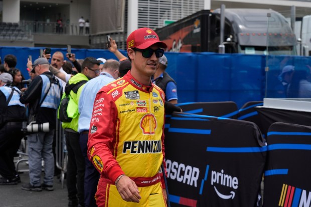 Joey Logano walks to his car before a NASCAR Cup...